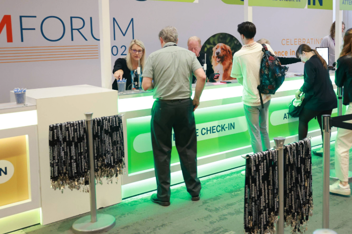Attendee standing at the registration booth with lanyards displayed